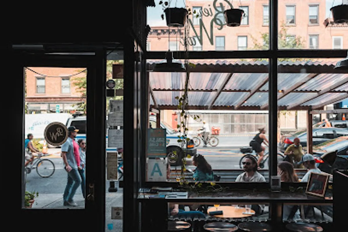 Crowded bar scene at BierWax Brooklyn with visible vinyl collections