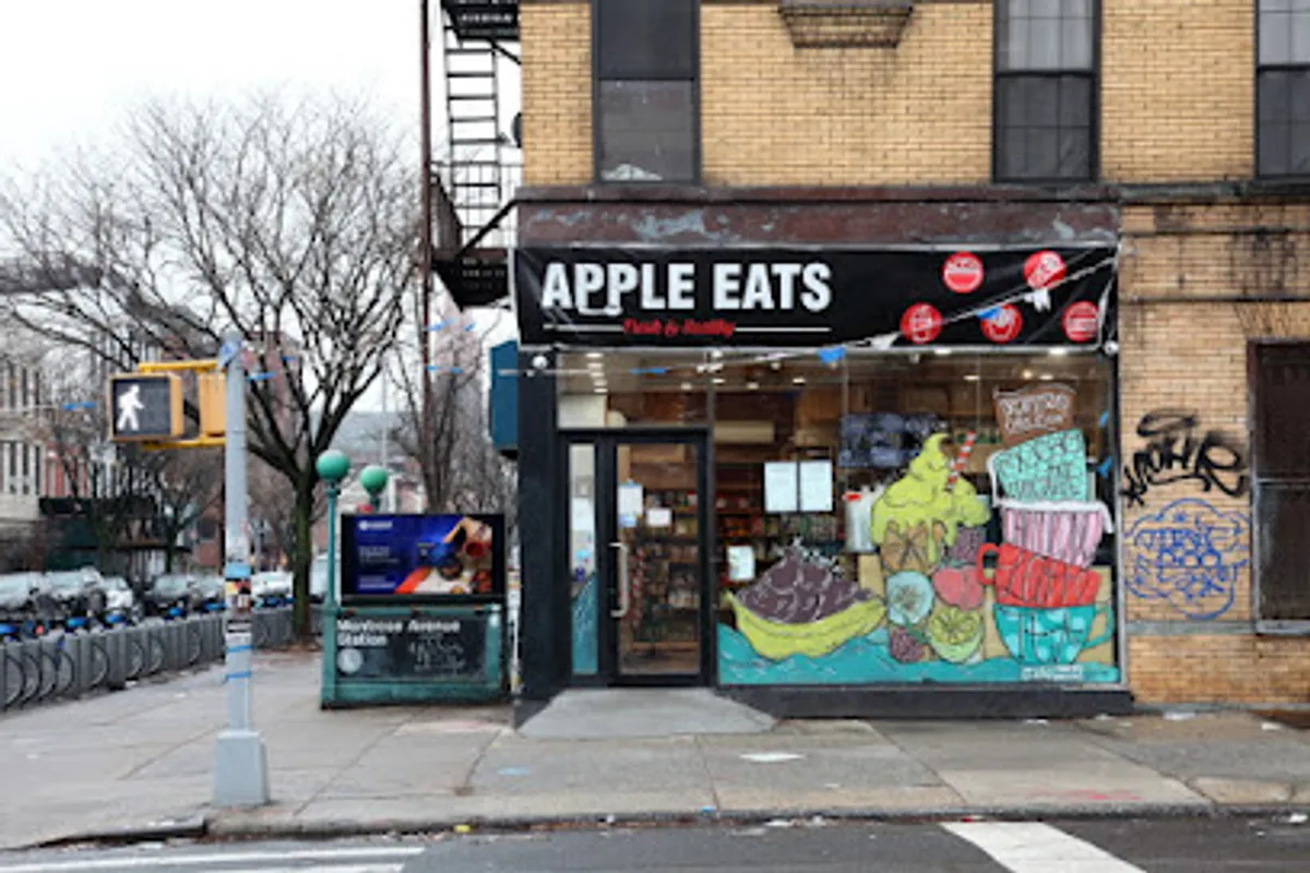 Interior view of Apple Eats cafe in Brooklyn with customers enjoying meals