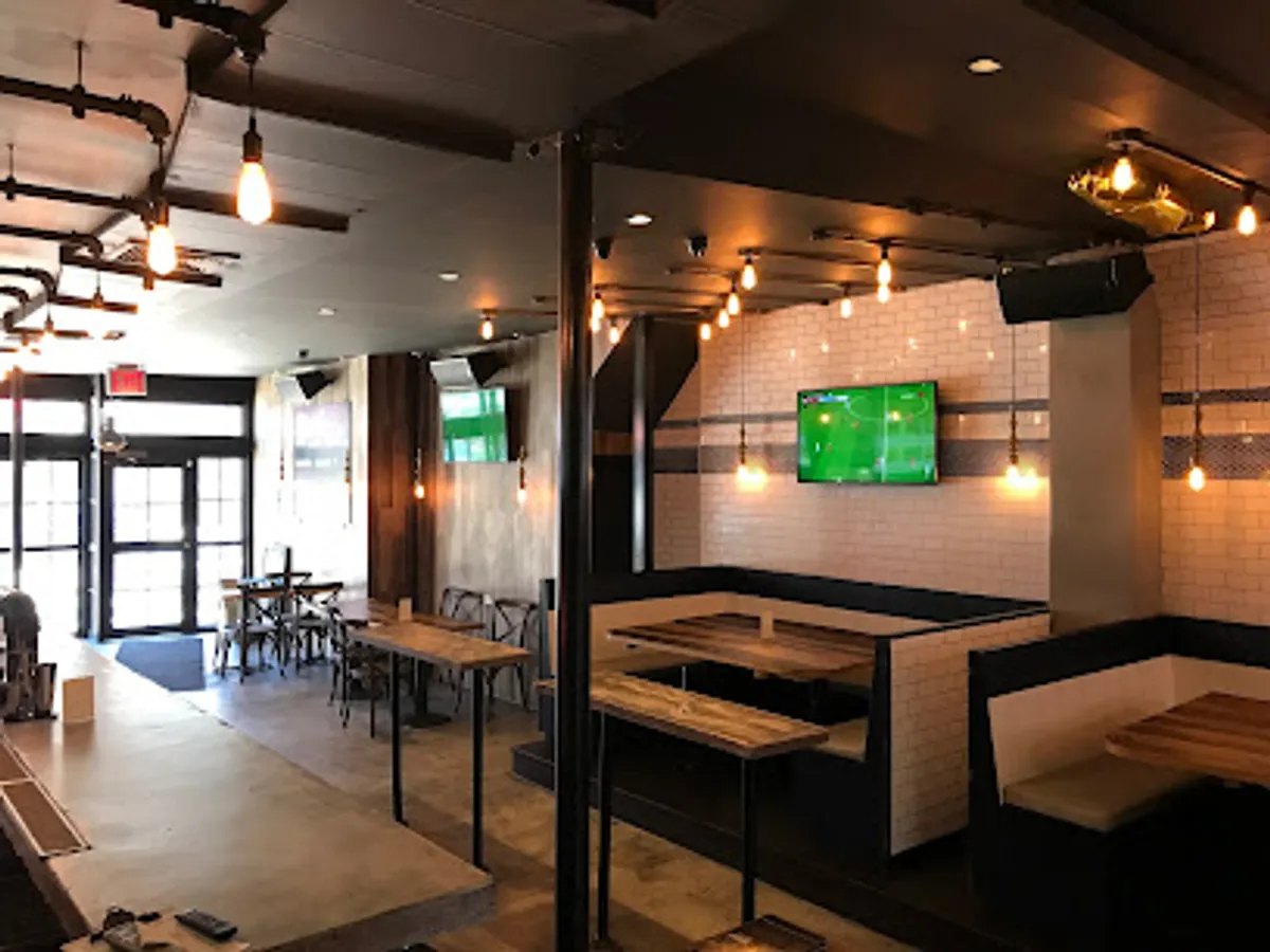 Interior view of Emblem Sports Bar in Williamsburg with patrons enjoying craft beers