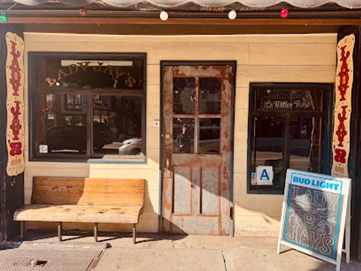 Interior view of Lady Jay's bar in Williamsburg, Brooklyn, showing patrons and bar setup