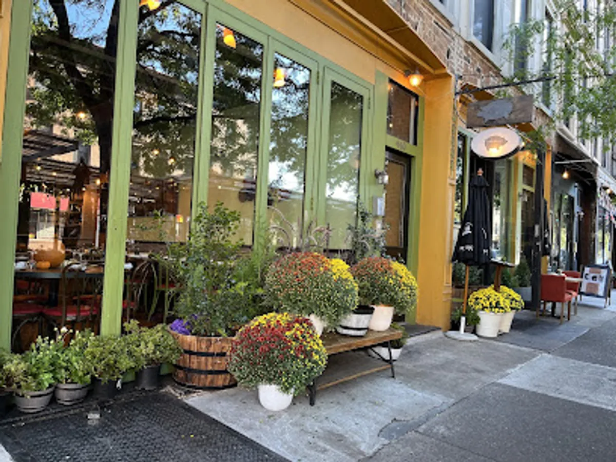Interior view of Osteria Brooklyn showing tables and rustic decor