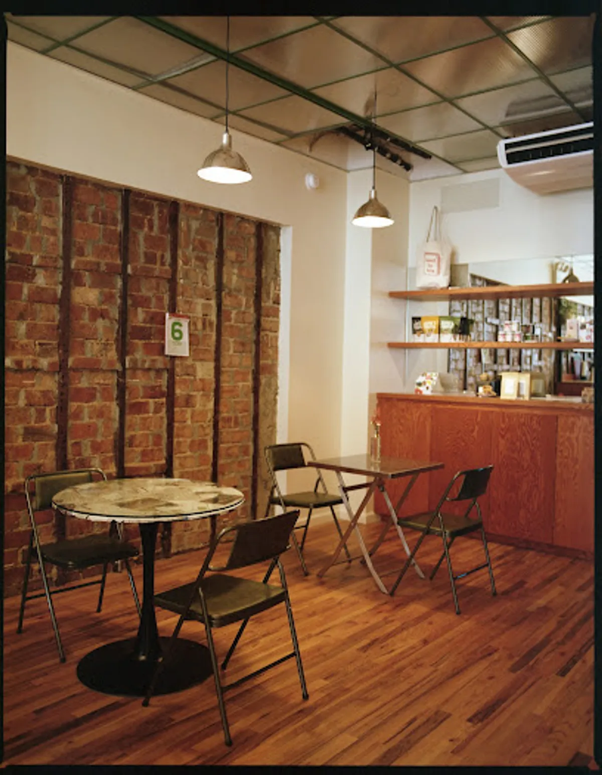 Interior view of Land to Sea cafe in Brooklyn, filled with guests enjoying beverages.