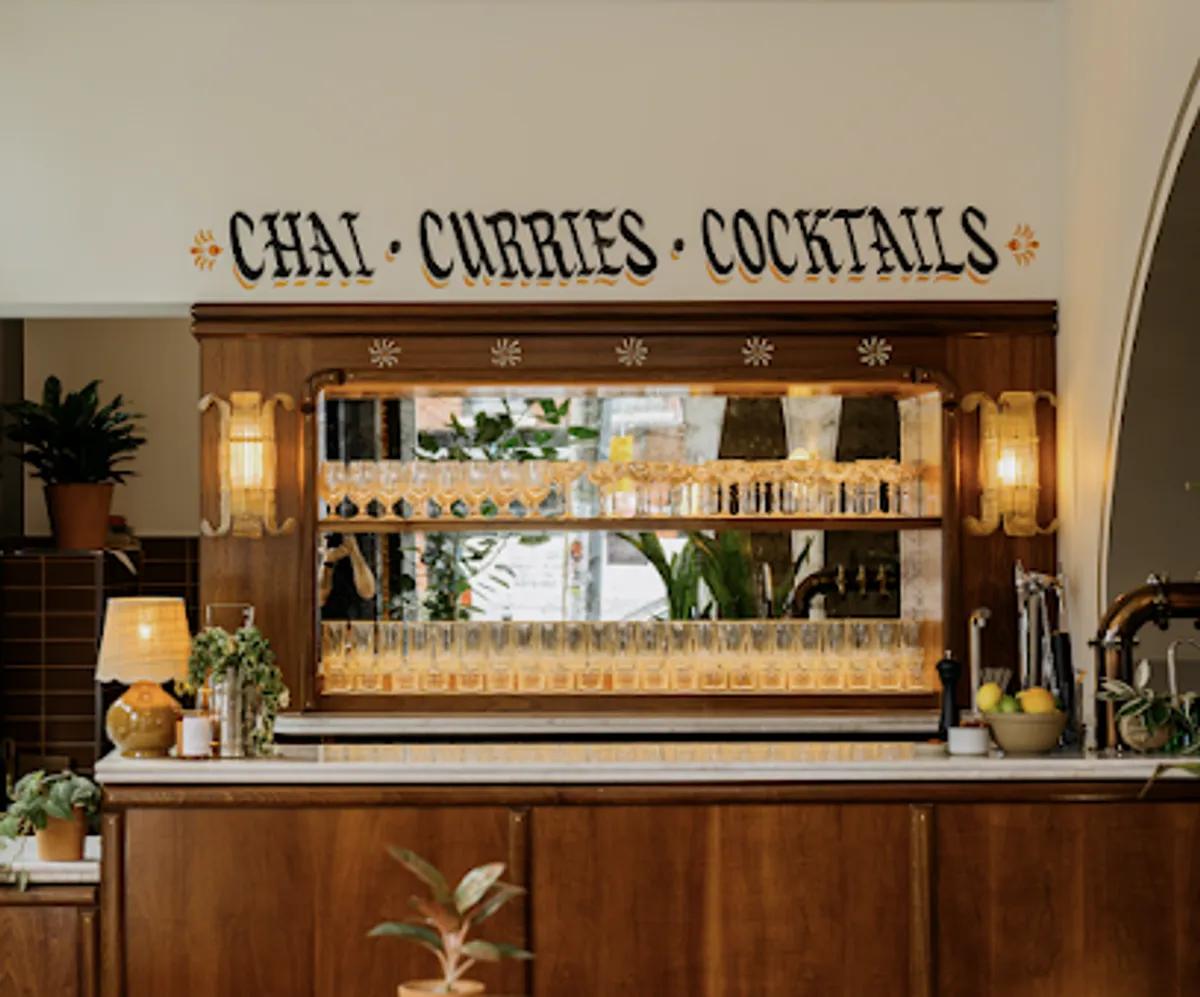 Interior view of INDAY All Day showing tables and Indian decor