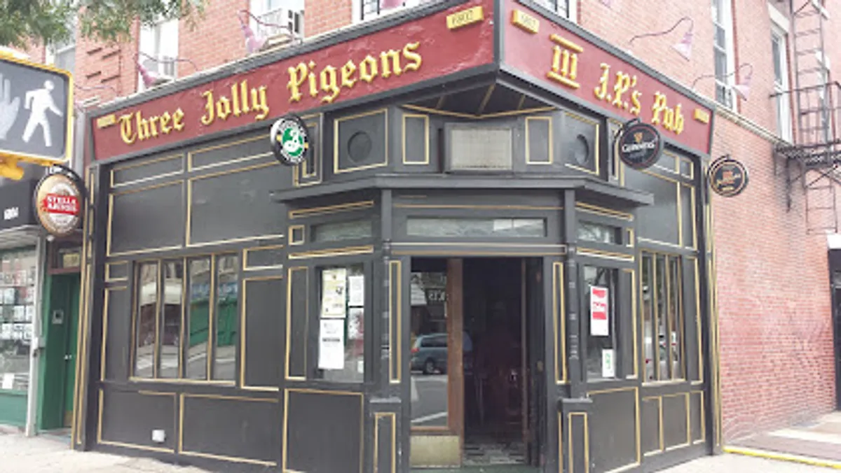 Cozy bar atmosphere with patrons enjoying drinks at Three Jolly Pigeons in Brooklyn