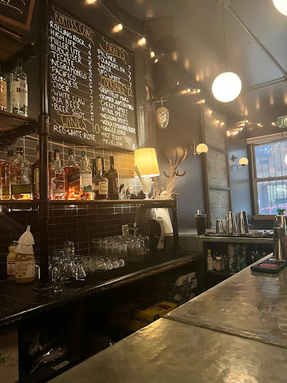 Cozy bar setting at Post No Bills with patrons enjoying drinks