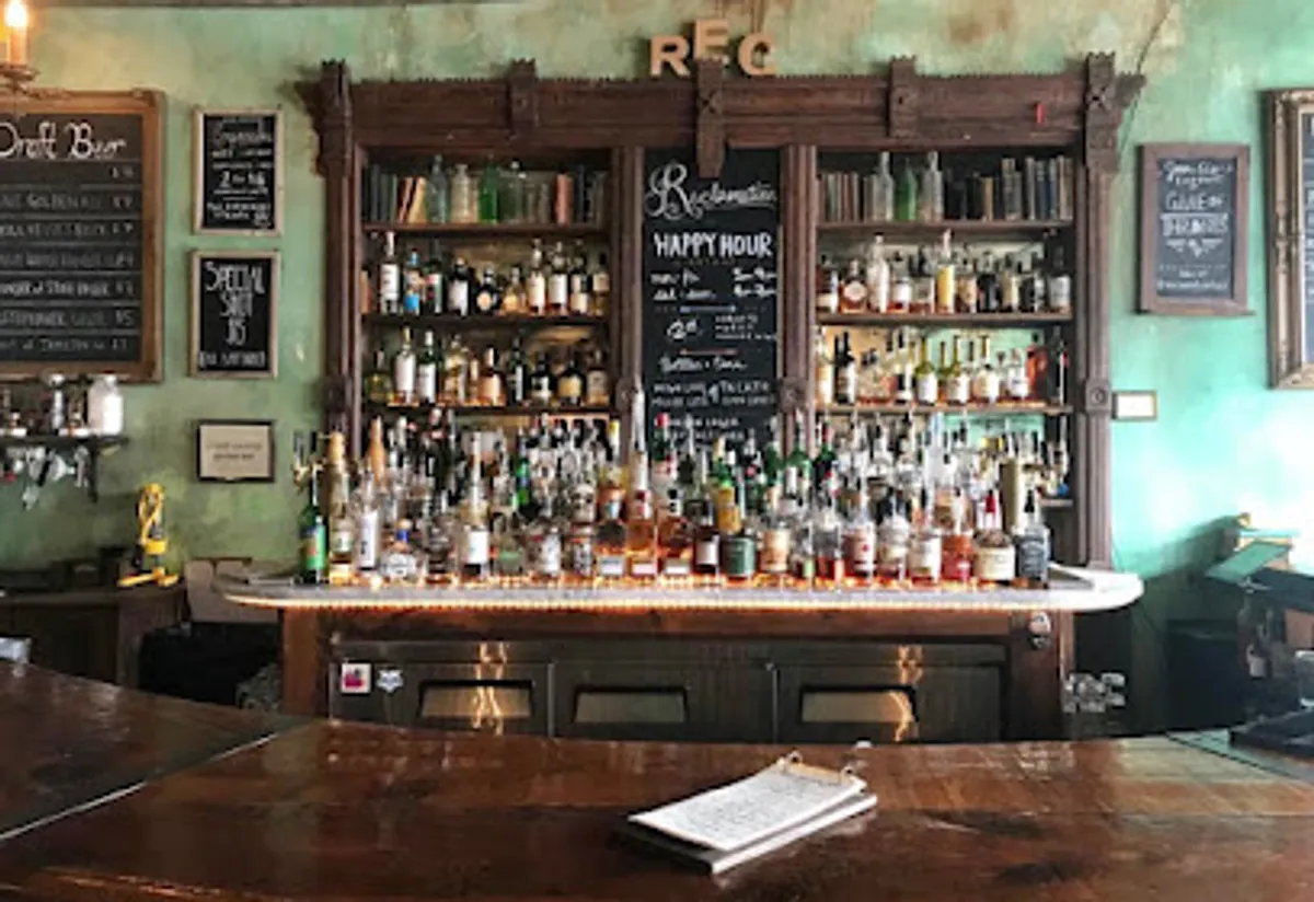 Cozy ambiance inside Reclamation Bar with dim lighting and wooden decor