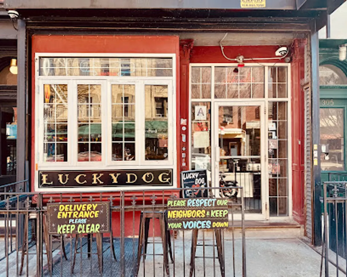 Interior view of Lucky Dog bar in Brooklyn, showing patrons and dogs enjoying together