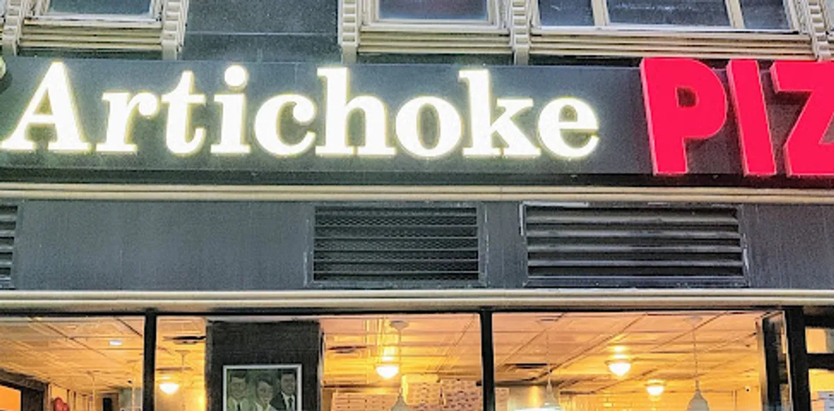 Customers enjoying delicious pizza at Artichoke Basille's in Brooklyn