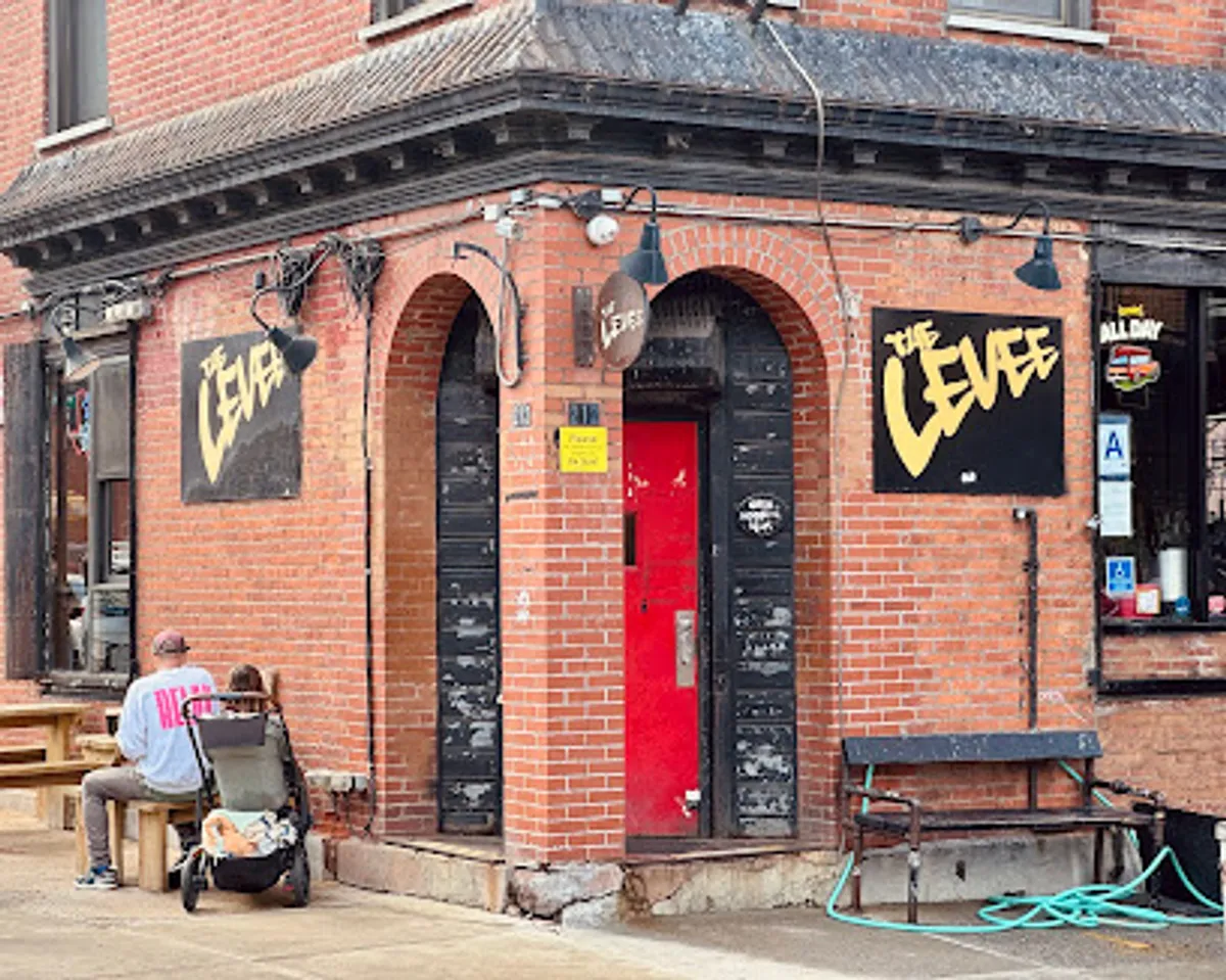 Patrons enjoying drinks and games at The Levee bar in Williamsburg, Brooklyn