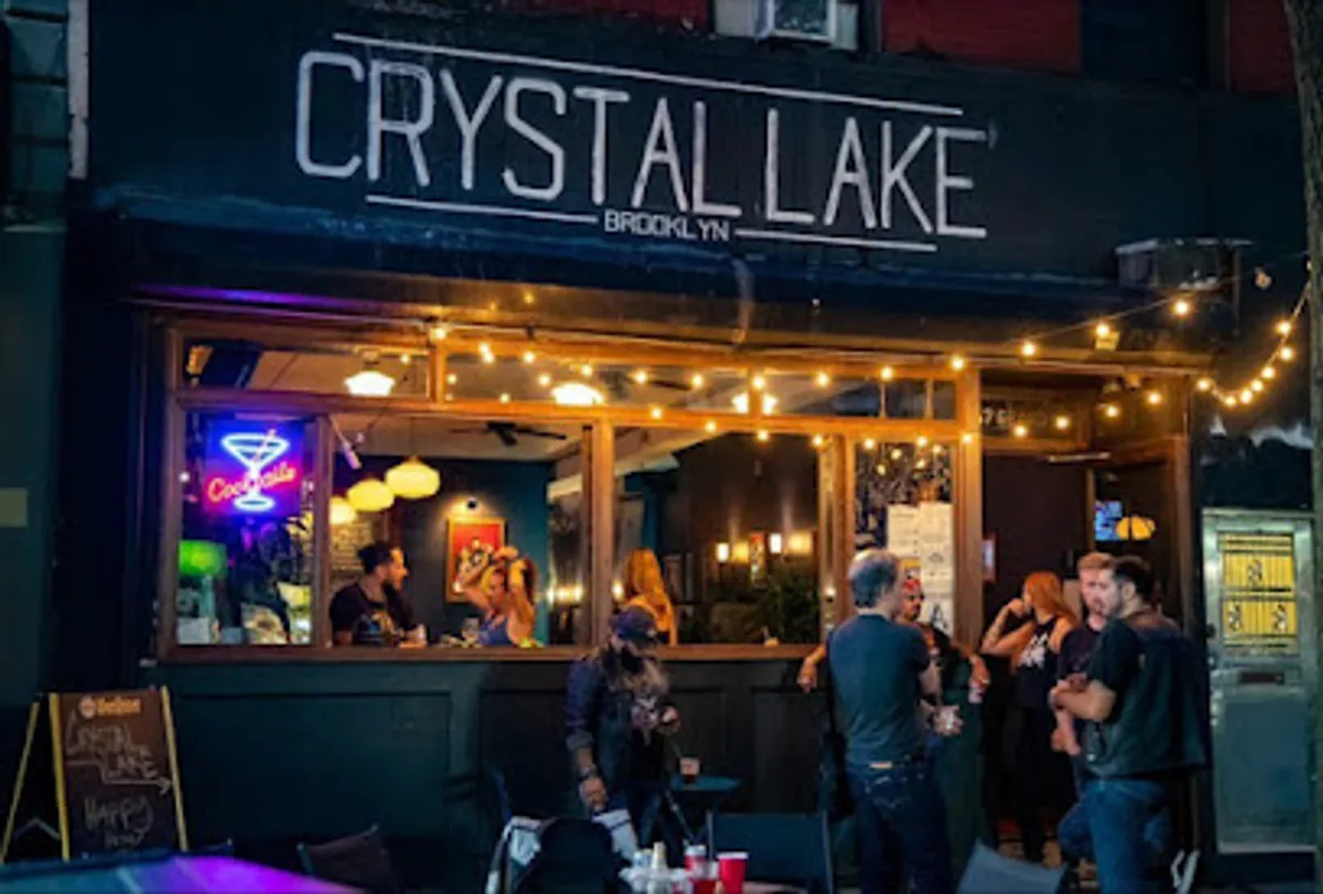 Crowded bar scene at Crystal Lake Brooklyn with vibrant lighting and decor
