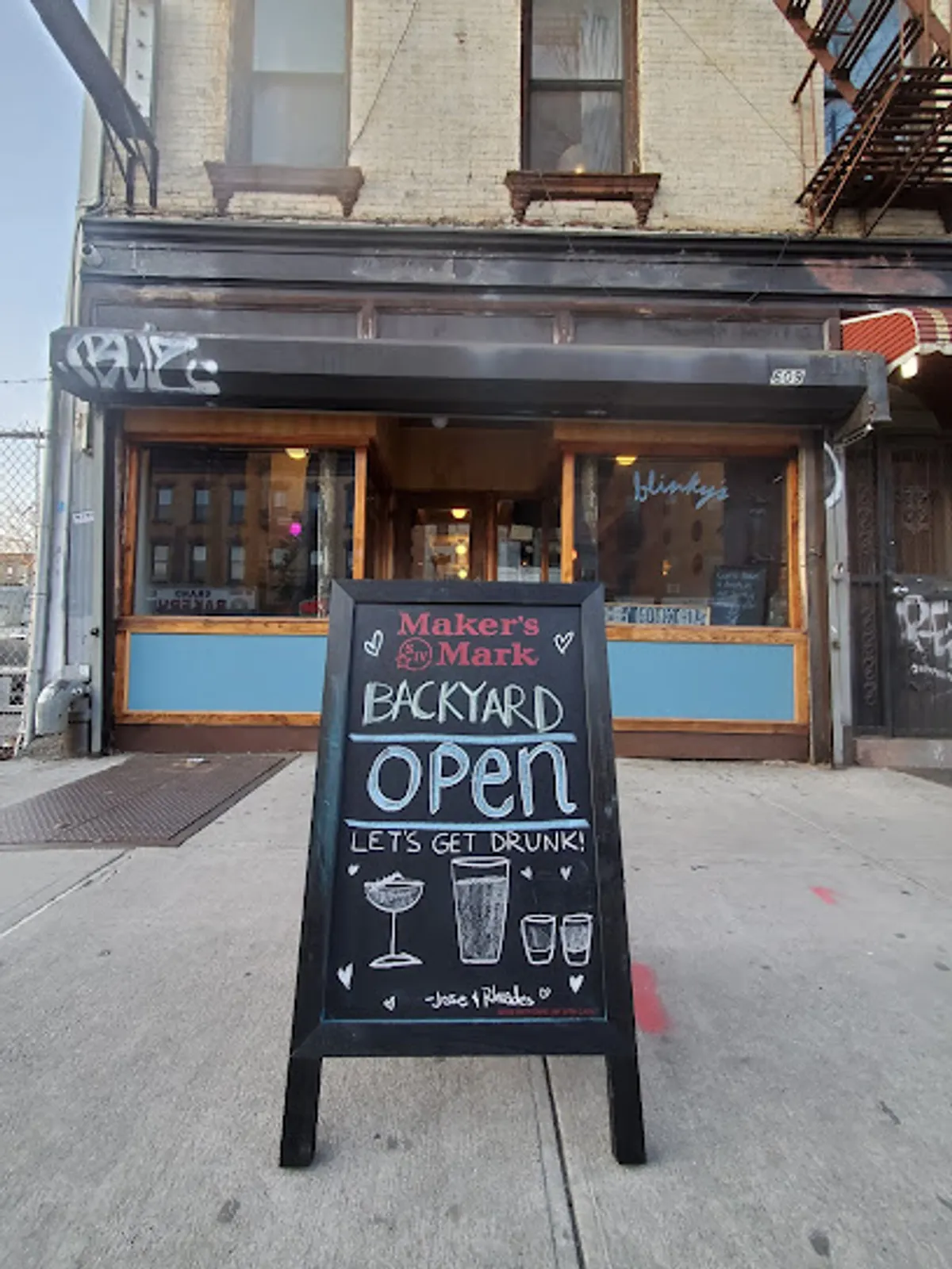 Customers enjoying drinks at Blinky's outdoor seating area in Brooklyn