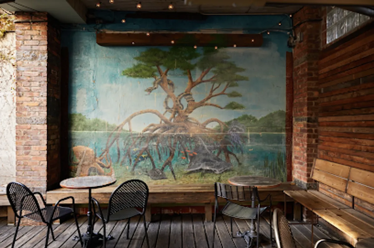 Cozy and trendy Broken Land bar with patrons enjoying drinks